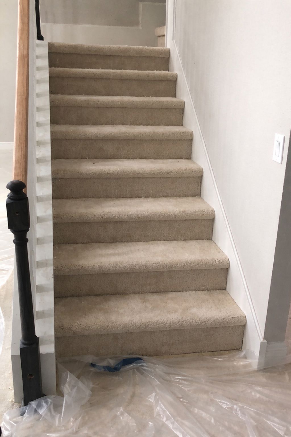 Stairs before renovation with carpet