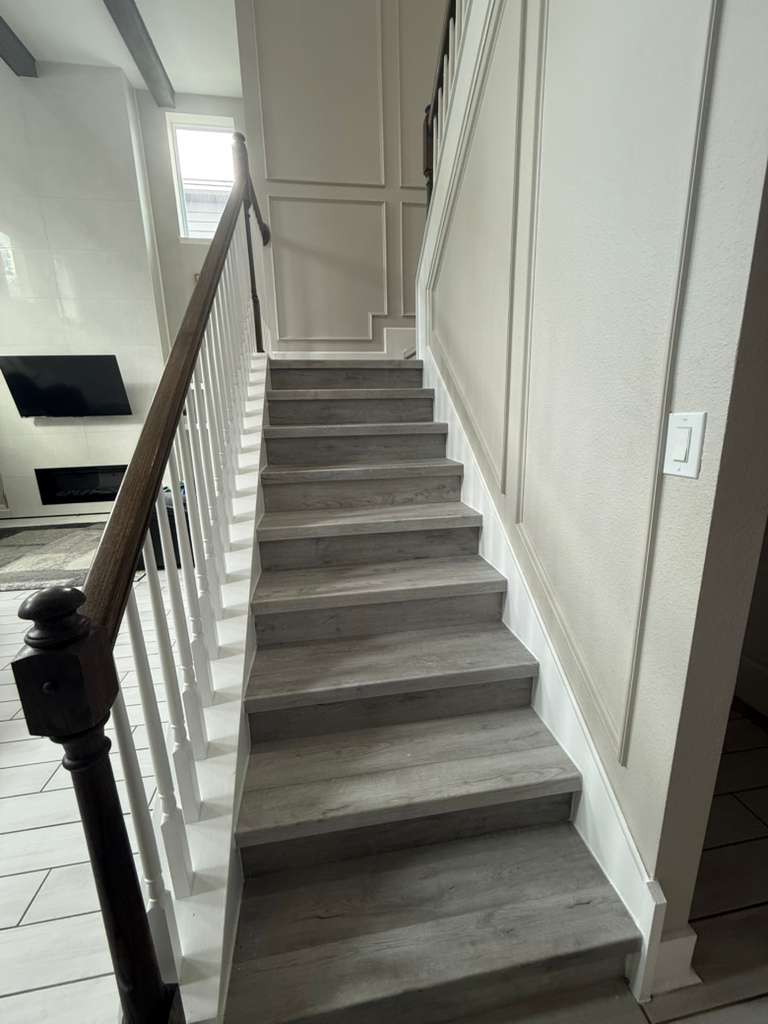 Stairs after renovation with LVP and boiserie