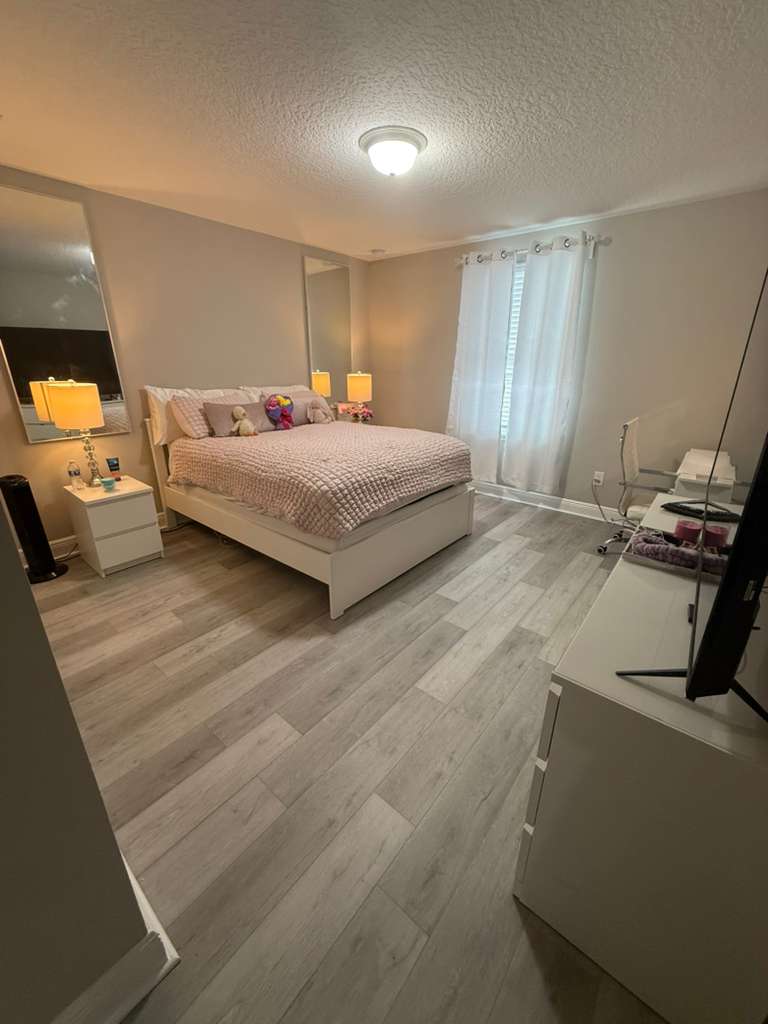 Bedroom after renovation with LVP flooring